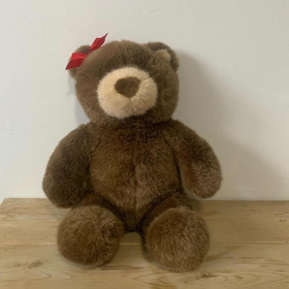 Brown Build-A-Bear plush with red bow